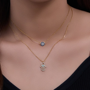 Double-layered gold S925 silver necklace with Evil Eye and Hamsa Hand diamond charms