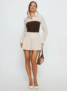 Detailed close-up of striped long sleeve shirt with brown knit tube top layered outfit