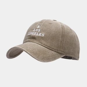Close-up of white A LOS ANGELES embroidery on washed brown cotton baseball cap