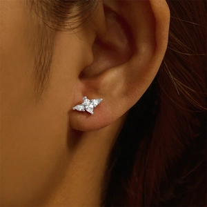 Detail of silver cartilage stud with marquise crystals worn on a model ear