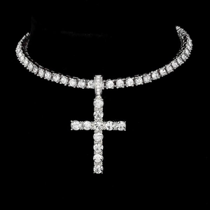 Close-up of hip-hop cross pendant with micro-pave crystals on a tennis chain