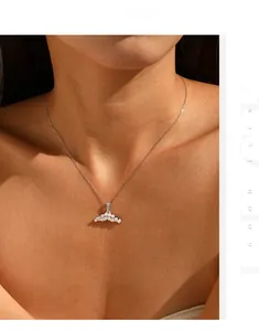 Close-up of elegant S925 silver mermaid tail pendant with white pearls on woman's neck