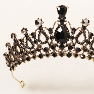 Close-up of gothic wedding crown featuring black rhinestones and vintage gold filigree