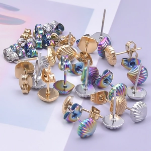 Macro detail of shell-shaped earrings in gold, silver, and iridescent 304 stainless steel