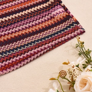 Detail of colorful wave pattern crochet knit fabric with hollow texture and dried flowers