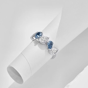 Macro detail of S925 silver ring featuring blue and white pear-cut zircon stones