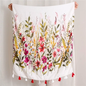 Detailed shot of vintage floral cotton linen shawl with colorful prints and red fringe tassels
