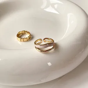 Adjustable gold open ring set with wavy texture and pearlescent pink inlay minimalist style