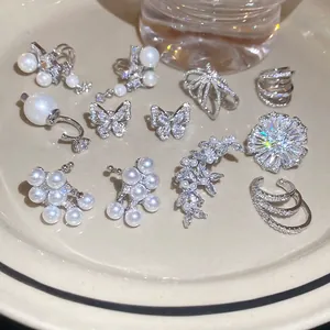 Silver-toned zircon pearl ear cuff set with butterfly and floral designs on tray