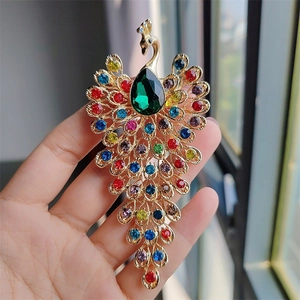 Detailed macro view of peacock brooch with gold plating and vibrant colorful rhinestones