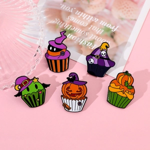 Detailed view of Halloween cupcake enamel pins with pumpkin and skull festive designs