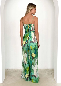 Back view of a green tropical floral jumpsuit with thin straps and elastic ruched back detail