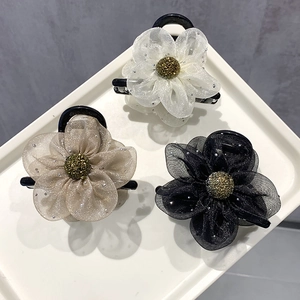 Elegant mesh flower hair claws in white champagne and black with gold center accents