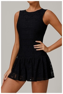 Detailed close-up of delicate crochet lace pattern and ruffles on a black sleeveless dress