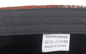 Detail view of the 100% polyester wash label and inner lining on the newsboy cap