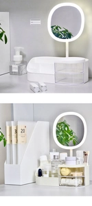 Detail of white vanity organizer featuring a built-in LED mirror and transparent drawers