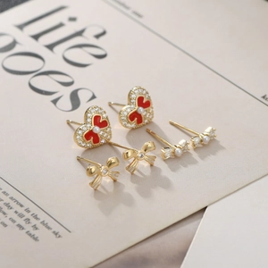 Three-pair S925 silver needle stud earring set featuring red heart and gold bow designs