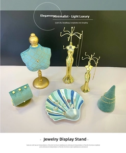 Detailed luxury jewelry display set with blue mannequin bust and golden necklace stands