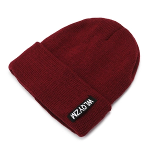 Classic burgundy knit beanie featuring a ribbed texture and white lettered black patch