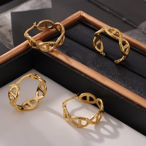 Elegant 18k gold-plated oval hollow earrings in minimalist design on jewelry display