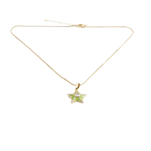 Detail of 18k gold plated star pendant necklace with green enamel and zircon stones