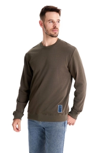 Detail of olive green sweatshirt showing ribbed crewneck and fashion label texture