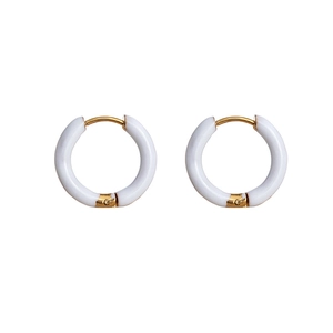 Close-up of elegant white circular hoop earrings with vacuum-plated 18K gold clasp