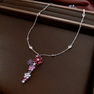 Detailed close-up of a floral cluster pendant with colorful cubic zirconia and silver chain