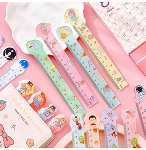 Flat lay of colorful 15cm plastic rulers with cute cartoon patterns and English phrases
