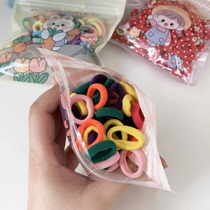 Colorful high-elastic towel hair ties for kids in transparent packaging hand-held