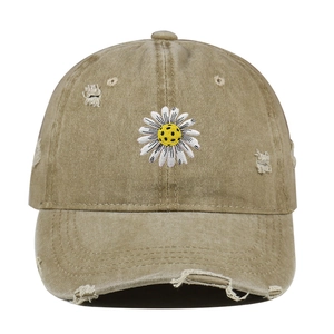 Vintage washed khaki baseball cap with daisy embroidery and distressed ripped details