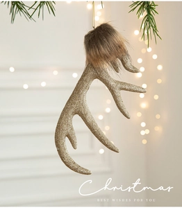 Detailed view of champagne gold reindeer antler ornament with brown fur and glitter