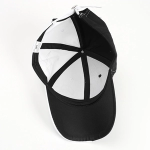 Detail view of the cotton baseball cap interior showing white lining and washing label