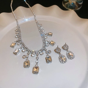 Macro shot of silver tassel necklace and teardrop earrings with sparkling crystals