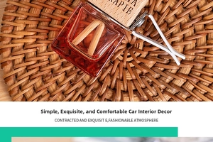 Close-up of red glass car perfume bottle with wooden lid and vent clip on rattan mat