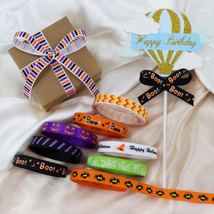 Detailed view of 10mm Halloween ribbons with pumpkin, spider, and Boo prints on satin
