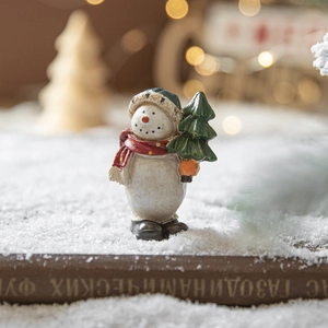 Painted resin snowman figurine with blue hat and green tree for Christmas tabletop decor