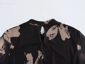 Detail of sheer mesh dress neck with double button closure and floral brushstroke print