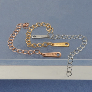Close-up of stainless steel extension chains in gold, rose gold and silver finishes
