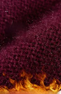 Dettaglio della trama a maglia viola con effetto fuoco che mostra calore e fibre soffici
