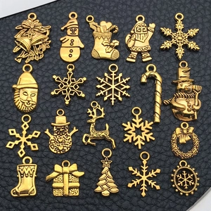 Macro shot of assorted golden Christmas charms for DIY jewelry making on dark background