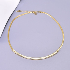 Macro detail of gold plated herringbone chain with micro-paved zirconia and K18 hallmark