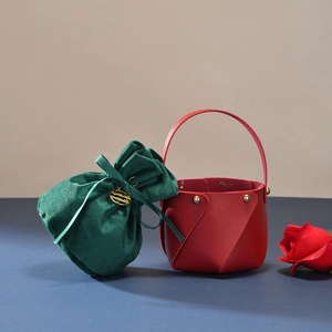 Detail of red leather Christmas apple gift basket and green velvet drawstring pouch