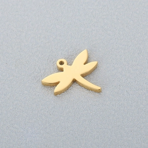 Detail shot of a polished golden dragonfly charm accessory made from stainless steel
