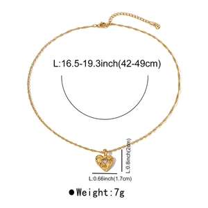 Detail view of heart pendant necklace with dimensions and single zircon inlay on white backdrop