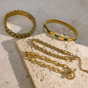 Four 18k gold-plated stainless steel bracelets with zircon and green gemstones