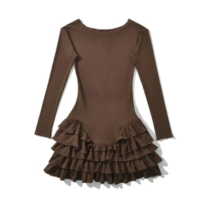Detailed view of brown long sleeve knitted dress with layered ruffle hem and crew neck