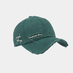 Detail of vintage washed baseball cap featuring frayed edges and side embroidery