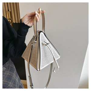 Close-up of a white triangular evening bag with sparkling silver rhinestones