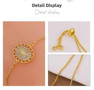 Macro detail of gold-plated Virgin Mary pendant with cubic zirconia and heart hollowed edge